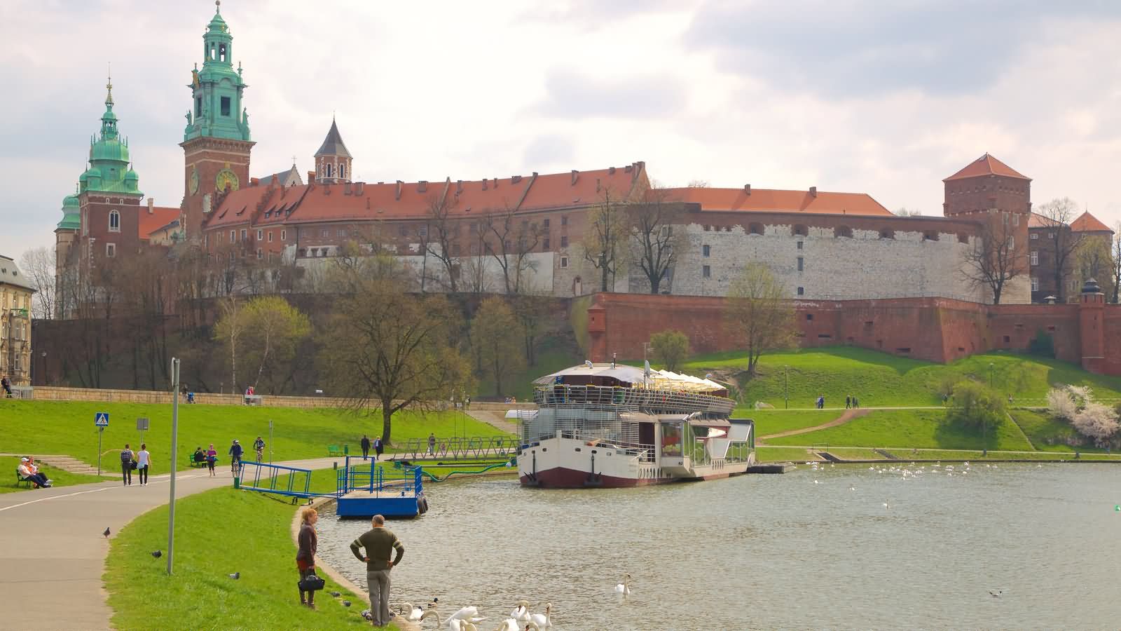Boat In Wisla River ANd Wawel Castle view