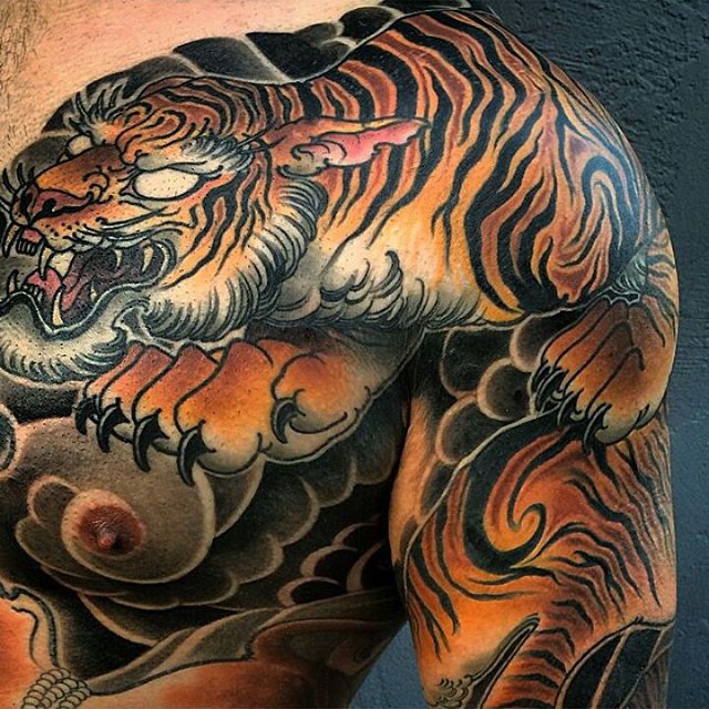 Colorful Animated Tiger Tattoo On Chest & Shoulder by Bill Canales