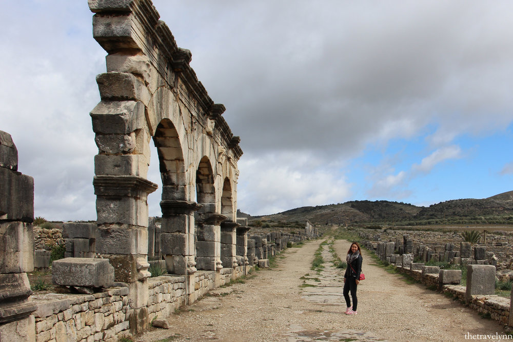 Girl Posing With The Ruins Of The Volubilis