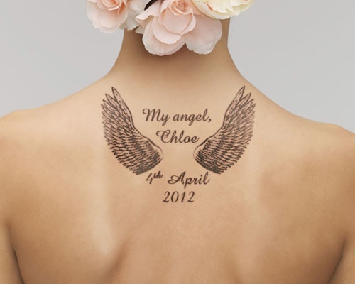 Grey Ink Angel Wings Memorial Tattoo With Wording & Date On Upper Back