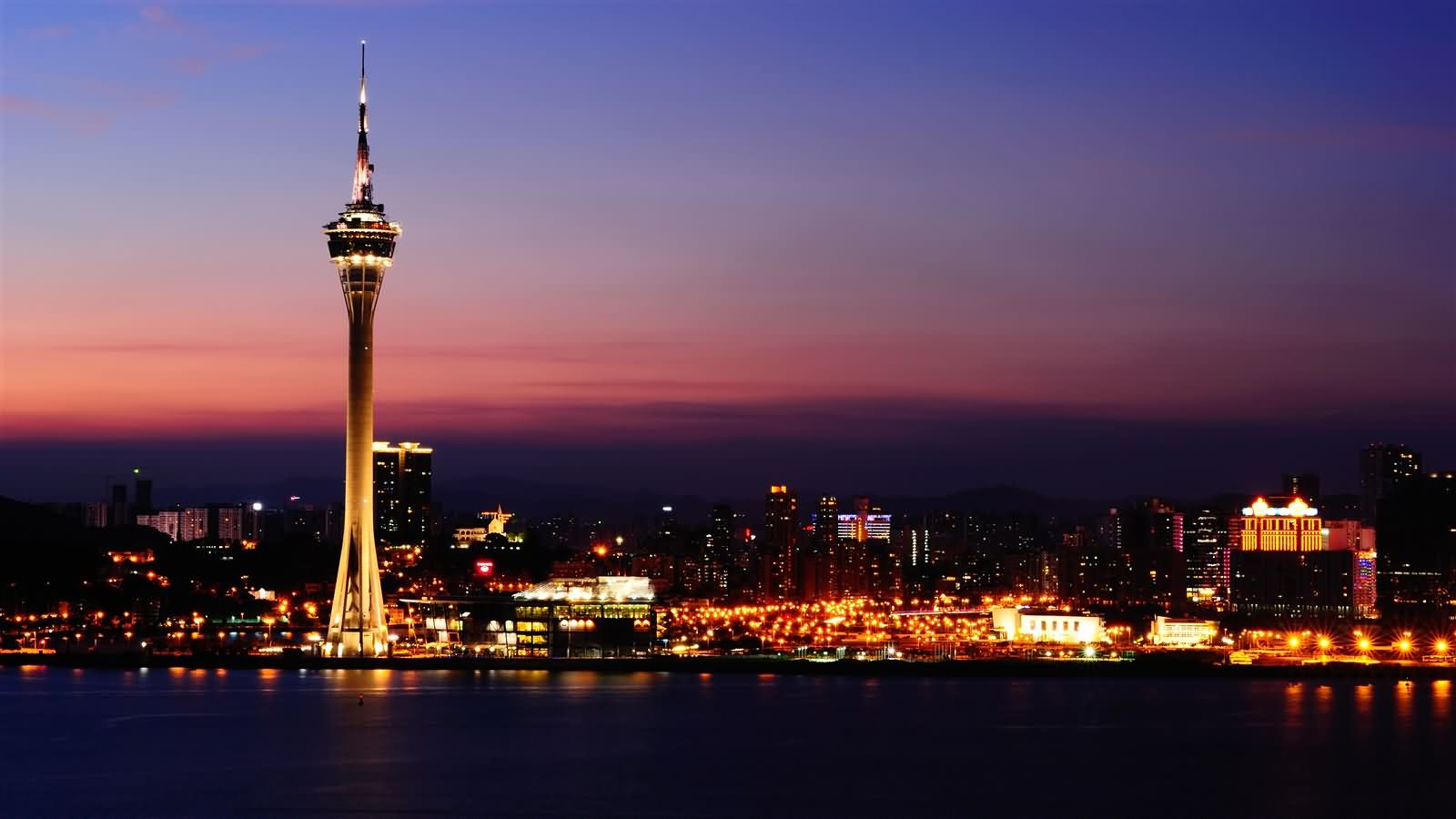 The Macau Tower And City Lit Up At Dusk