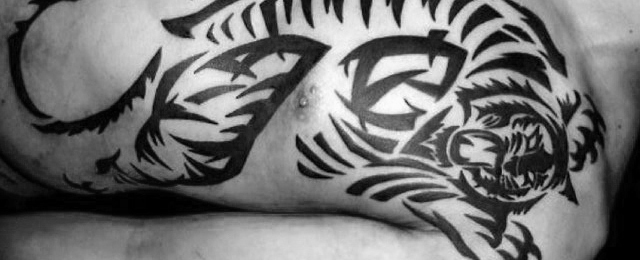 Amazing Black Ink Tribal Tiger Tattoo On Male Chest