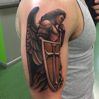 Amazing Brown Archangel Tattoo With Sword & Shield Tattoo On Forearm