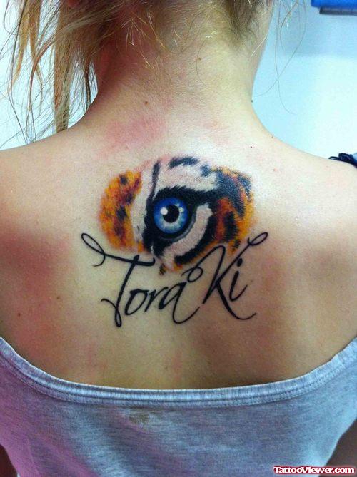Amazing Colorful Tiger Eye Tattoo On Girl Upper Back