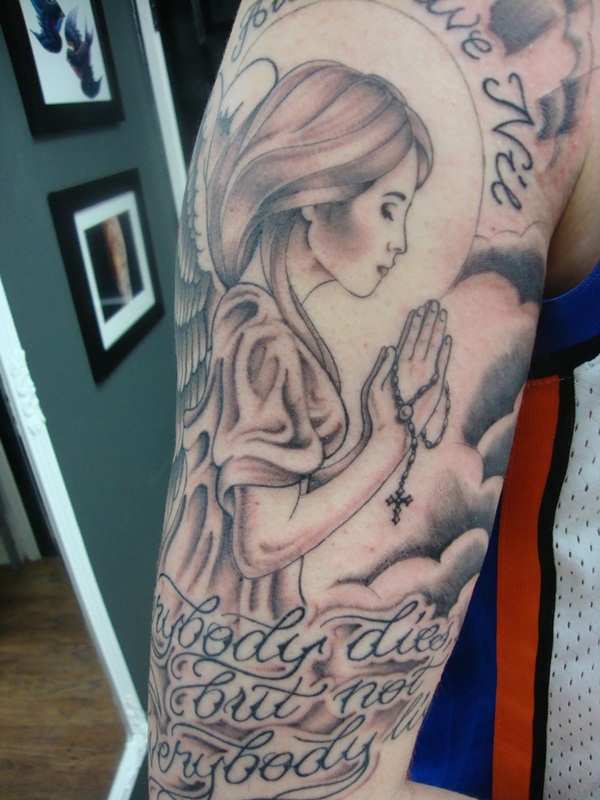 Amazing Grey Ink Praying Angel Memorial Tattoo With Lettering On Half Sleeve