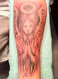 Beautiful Praying Angel With Halo Tattoo Design On Arm