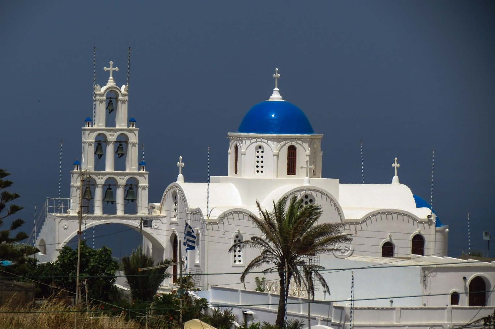 Bells And Blue Dome Church In Santorini