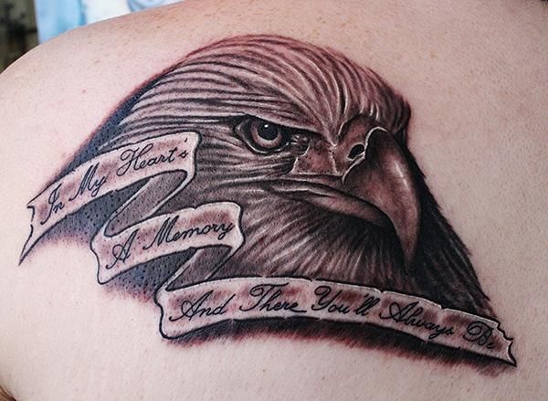 Black And Grey Bald Eagle Head Tattoo On Side Back With Wording – In My Heart’s A Memory And There You’ll Always Be
