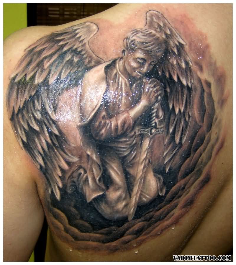 Black & Grey Ink Praying Angel With Sword Tattoo On Back Shoulder For Men