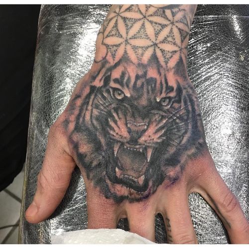 Black Ink Roaring Tattoo Design For Hand