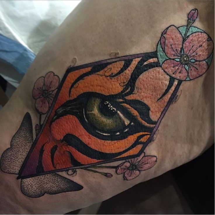 Colorful Abstract Tiger Eye Tattoo On Forearm
