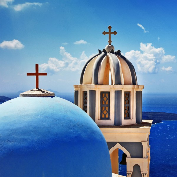 Cross On The Blue Dome Of Church In Santorini