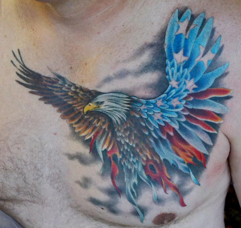 Flying Bald Eagle With American Flag Colored Wings Tattoo On Chest