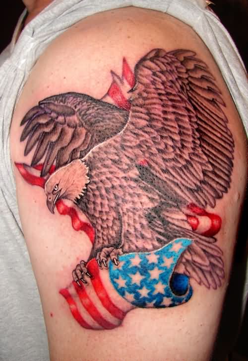 Grey Bald Eagle Carrying American Flag Tattoo On Shoulder