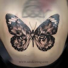 Incredible Tattoo Of Tiger Eyes In Butterfly On Back