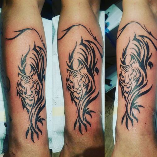 Lined Walking Tribal Tiger Tattoo On Forearm