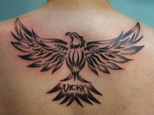Open Winged Tribal Eagle Tattoo With Name On Back