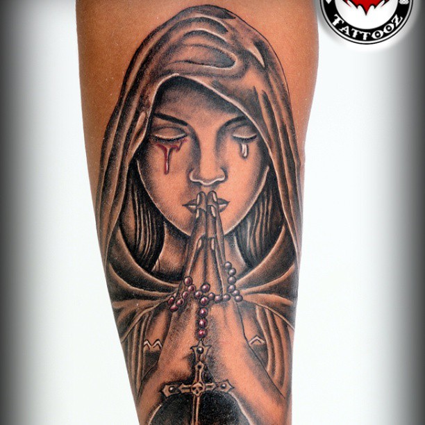 Praying Angel With Bleeding Eye & Rosary Tattoo On Forearm
