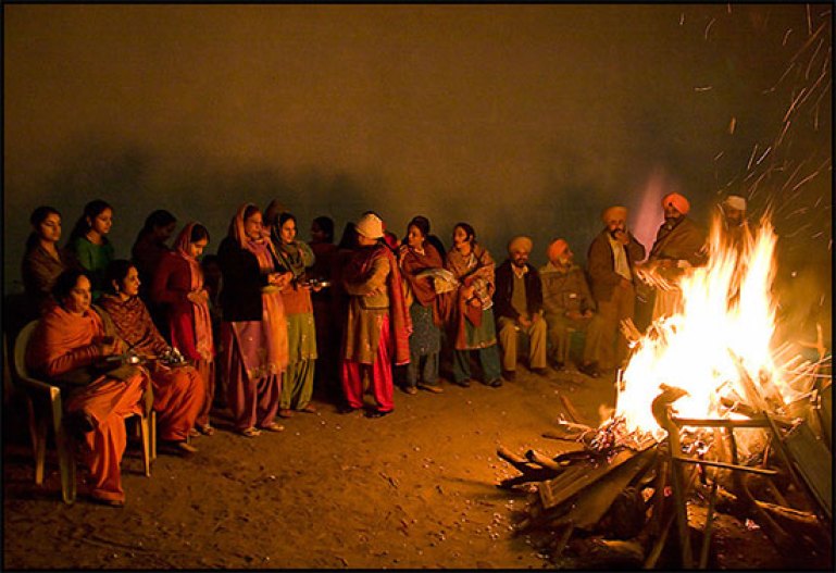 Punjabi People Celebrating Lohri By Sitting Around Bonfire At Night