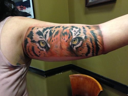 Realistic Tiger Eyes Tattoo On Bicep For Men