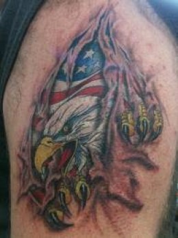 Ripping Skin American Flag Colored Eagle Tattoo On Shoulder