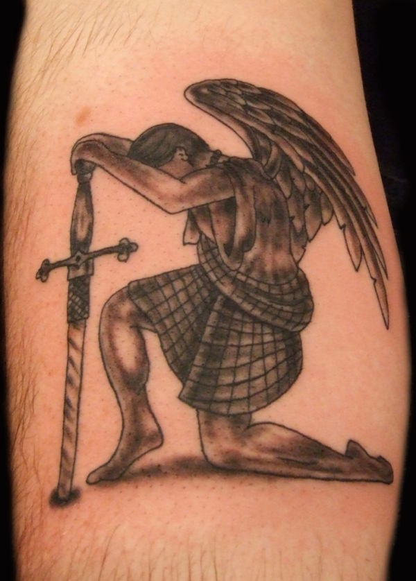 Angel kneeling down wearing a kilt and holding a Celtic sword tattoo on leg