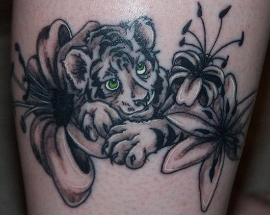 Black Ink Cute Green Eyed Baby Tiger Tiger With Flowers Tattoo Design