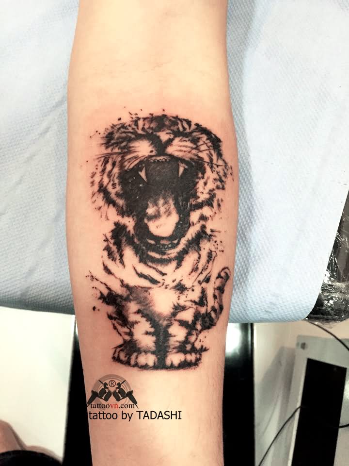 Black Ink Roaring Baby Tiger Tattoo On Forearm By Tadashi Tattoo