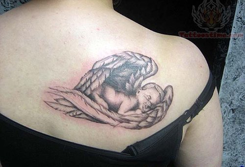 Black Ink Sleeping Cupid Cherub In Angel Wings Tattoo On Girl Back Shoulder