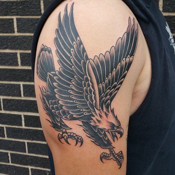 Black Ink Traditional Attacking Eagle Tattoo On Shoulder For Men