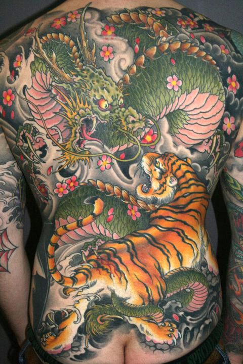 Colorful Dragon Vs. Tiger Tattoo On Male Full Back