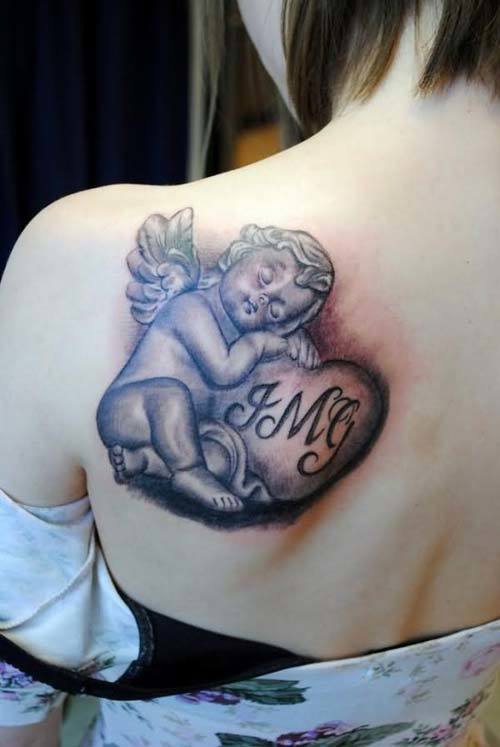 Cute Baby Angel With Heart Memorial Tattoo On Girl Back Shoulder