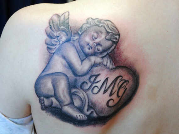 Cute Grey Ink Angelic Cherub With Heart Tattoo On Girl Back Shoulder