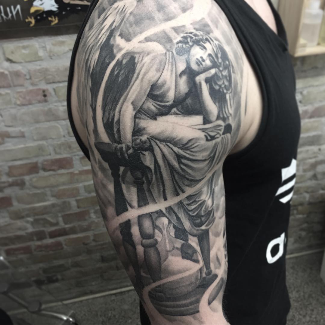 Gray Ink Beautiful Angel Sitting On Hourglass Tattoo On Half Sleeve