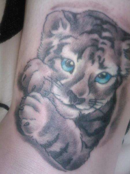 Grey Ink Baby Snow Tiger With Blue Eyes Tattoo On Arm