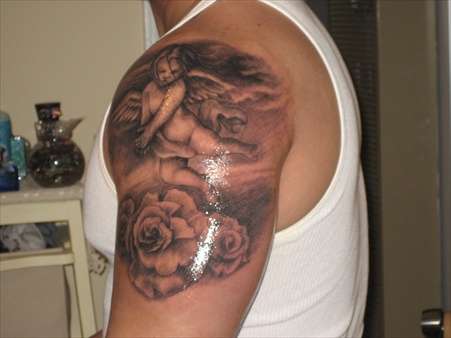 Grey Ink Cherub In Clouds With Roses Tattoo On Male Shoulder
