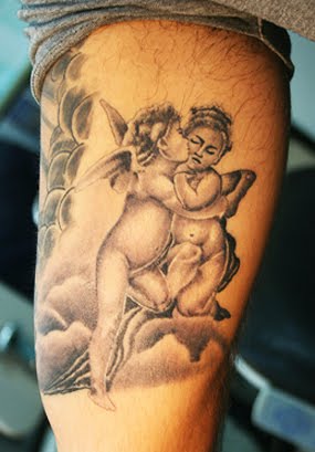 Grey Ink Cute Baby Angels Kissing Tattoo On Leg