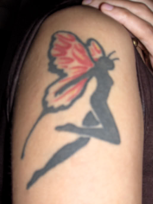 Small Black Angel With Butterfly Wings Tattoo On Girl Shoulder