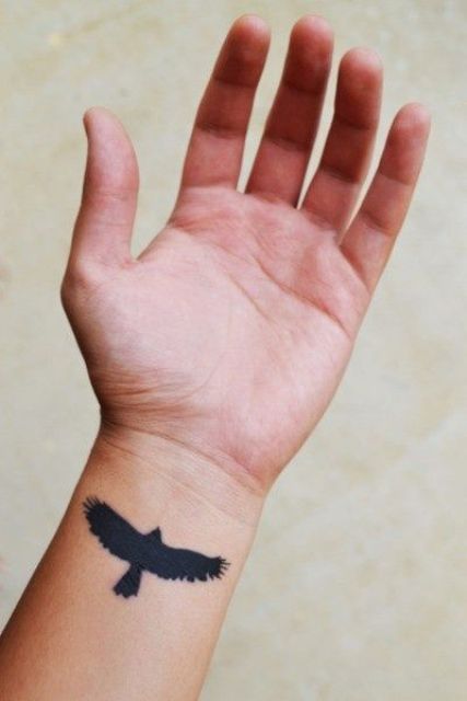 Small Black Silhouette Flying Eagle Tattoo On Wrist