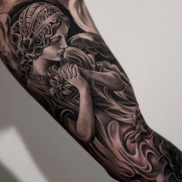 Stunning Black Ink Praying Angel Tattoo On Sleeve