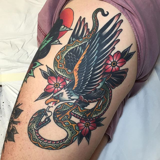 Traditional Eagle Vs. Snake Tattoo With Flowers On Thigh