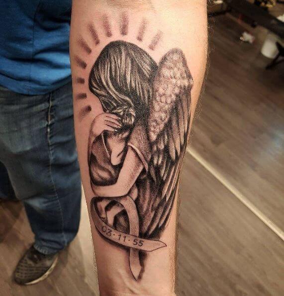 Wonderful Grey Ink Mother Angel Holding Baby With Date Banner Tattoo On Forearm