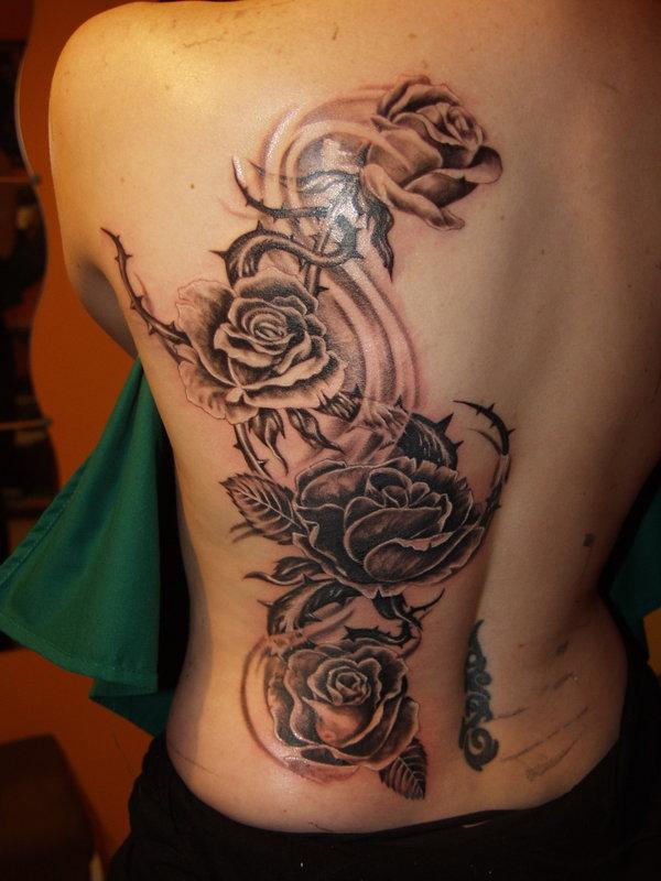 Black & Grey Ink Tribal Roses Tattoo On Girl Back