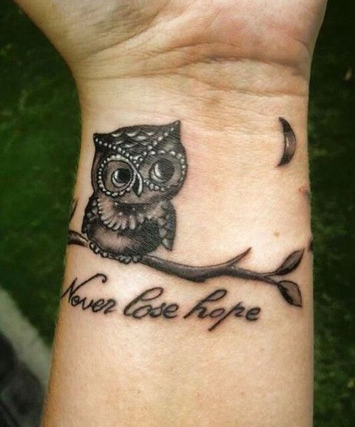 Black Ink Cute Baby Owl Tattoo With Wording ‘Never Lose Hope’ On Wrist