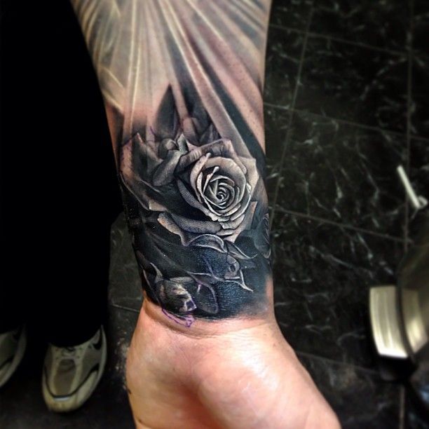 Black Rose With Light Rays Tattoo On Arm