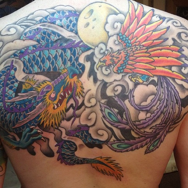 Colored Traditional Dragon Vs. Phoenix Tattoo On Back