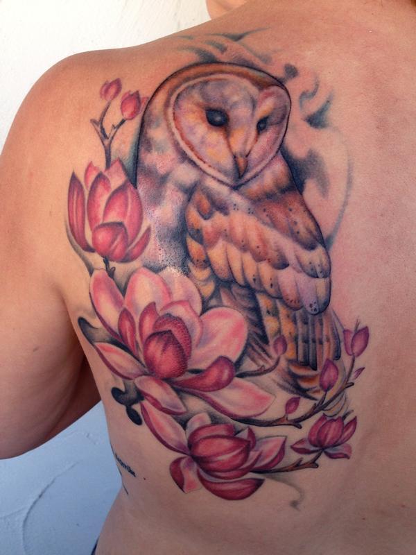 Colorful Barn Owl With Magnolias Tattoo Design On Back For Girls