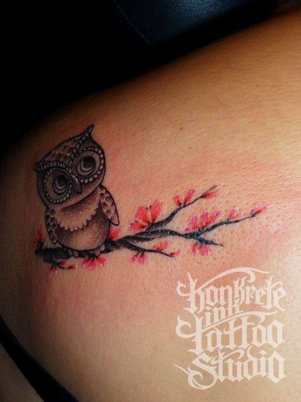 Grey Ink Cute Baby Owl Sitting On Floral Branch Tattoo Design On Back Shoulder For Girls