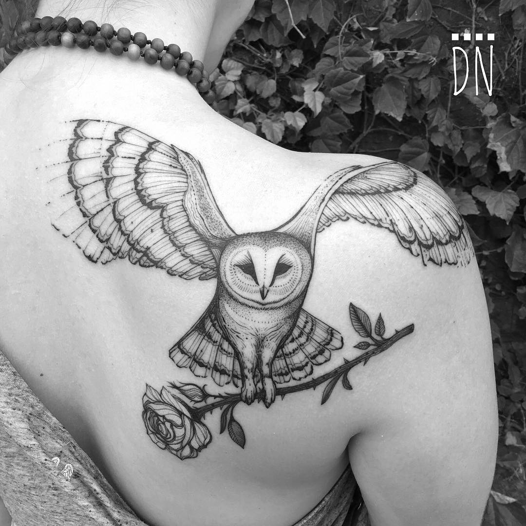 Grey Ink Flying Barn Owl Carrying Rose Tattoo On Girl Shoulder Back