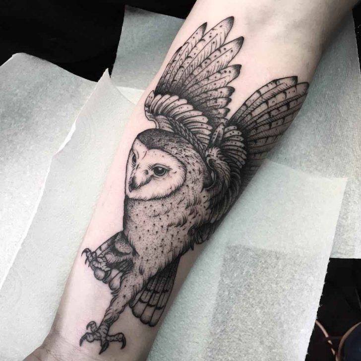 Grey Ink Flying Barn Owl With Open Wings Tattoo On Forearm